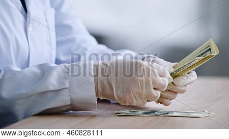Close-up Female Hands In White Latex Gloves Pharmacist Doctor Scientist In Medical Coat Sits At Tabl