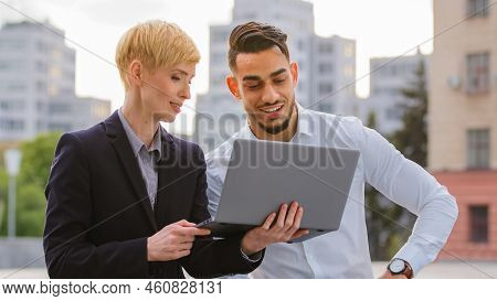 Serious Diverse Multiracial Couple Colleagues Arabic Hispanic Man And Caucasian Woman Standing Near 