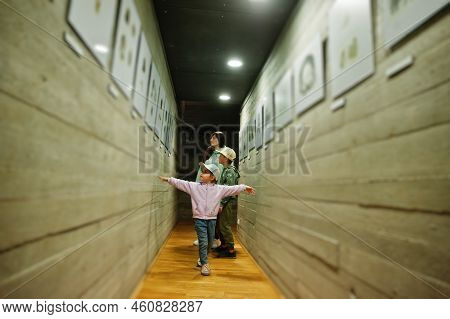 Mother With Children Exploring Expositions In Museum Halls.