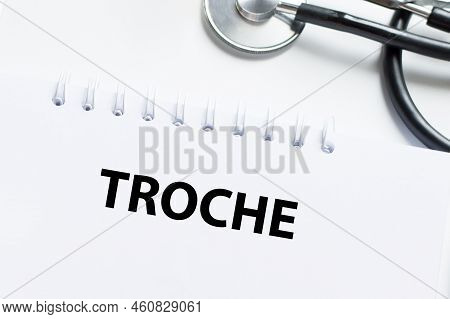 Troche Text On Notepad On A Light Table Next To A Stethoscope
