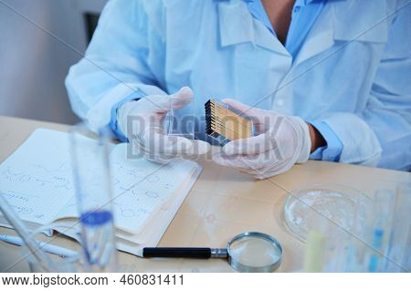 Details: Scientist Chemist Hands In Medical Gloves Holding A Container With Litmus Or Reagent Paper 