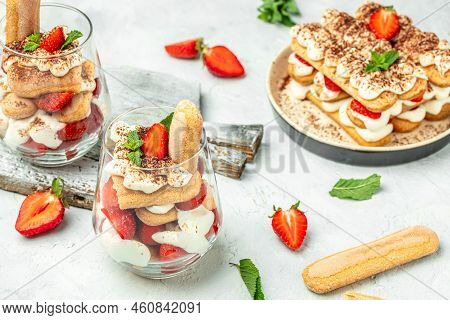 Tiramisu. Homemade Tiramisu With Fresh Strawberry, Mascarpone And Mint In Glass On Light Background.