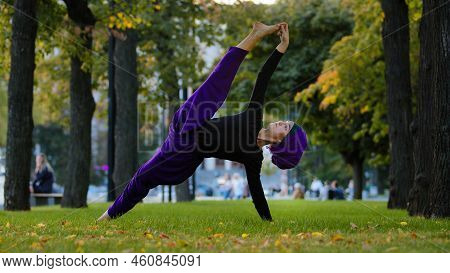 Strong Sportive Islamic Girl In Hijab Yoga Teacher Woman Stands In Side Plank On Grass In Park Doing