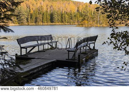 Pier With Benches On A Forest Lake In The Autumn Forest. Naroch Park Blue Lakes