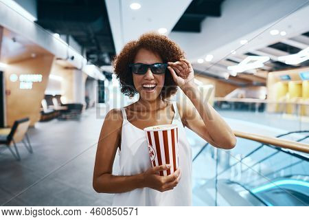 Young Cheerful Woman In 3d Glasses With Popcorn In Her Hands. Going To The Cinema. High Quality Phot