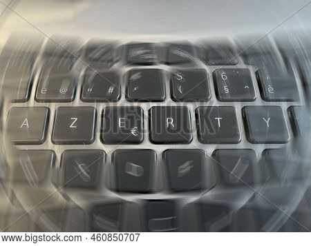 Radial Blurred Close-up View On An A Grey Azerty Keyboard Letters In The Office