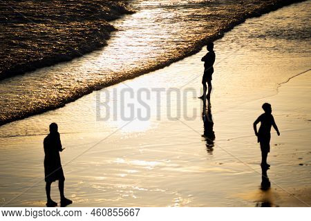 People Walking E Se Divertindo On The Sand Of Beach In The Late Afternoon.
