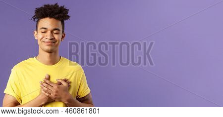 Always In My Heart. Touched, Carefree Handsome Young Man With Dreads, Yellow T-shirt, Close Eyes And