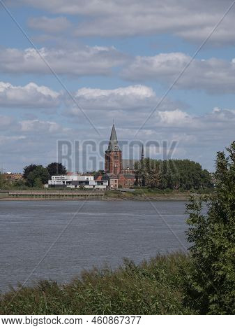 Vertical Landscape Photo With The River Scheldt And A View Of The Sint Martinuskerk In Zwijndrecht, 