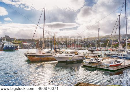 Faroe Islands. Denmark. 11 May. 2022. Boats Parked In The Bay, Among The Beautiful Small, Colorful H