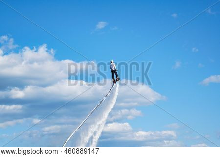 Water Extreme Sport. The Guy Is Flying At The Aquatic Flyboard.