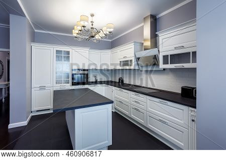 Fashionable Kitchen With Grey Walls And White Furniture, A Kitchen In A Modern Classic Style With Gr