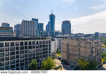 7.22.2022 Warsaw, Poland. Drone Aerial View. Contrast Between Pre-war Bricky Tenement House And Neom