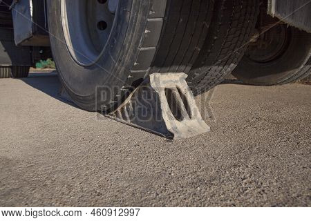 Full Metal Wheel Chock Under Trailer. Ground View