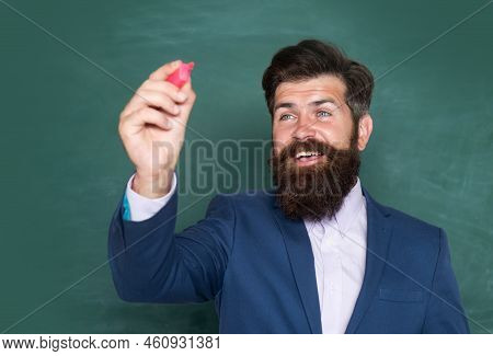 Portrait Of A Funny Teacher Or Professor Near Blackboard. Thinking Serious Mature Teacher. Mature Pr