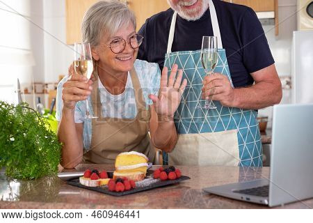 Beautiful Senior Couple In The Home Kitchen After Baking Their Homemade Plumcake They Hold Two Glass