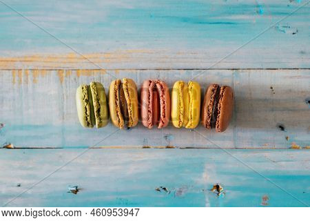 Coloured Macarones Biscuits On A Blue Wooden Table Background - Concept Of Bakery And Party Lifestyl