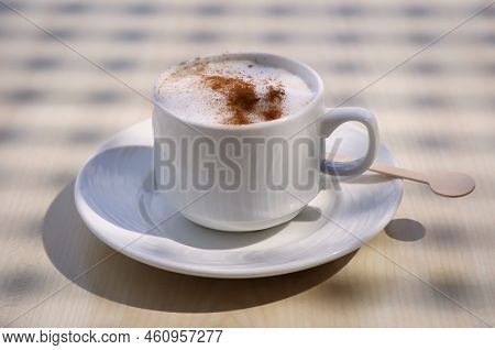 A Cup With Latte Macchiato, Cafe Latte Stands On A Table.