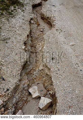 Erosion Grooves After Rains In A Dirt Road. Deep Ground After A Storm. Lack Of Drainage Will Cause S