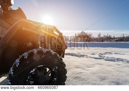 Side Pov Close-up Detail View Of Quad Bike Offroad Vehicle Parked In Snowdrift Track On Sunny Snowy 