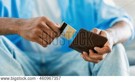 Finance And Electronic Money. Unrecognizable African Ameican Man Taking Credit Card Out Of Wallet, C