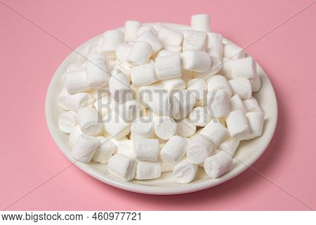 Mini Marshmallows On A Pink Background. A Plate Full Of Marshmallows. Dessert Ingredient