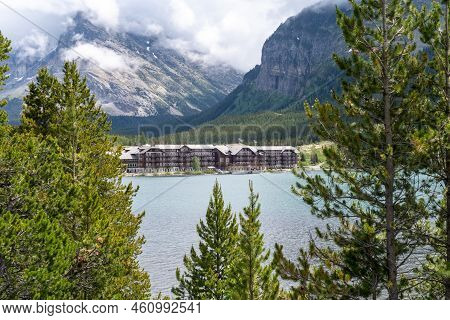 Montana, Usa - July 4, 2022: Historic Many Glacier Hotel In Glacier National Park On An Overcast Rai