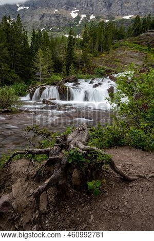 Redrock Falls In Glacier National Park Usa, Silky Water On A Cloudy Day