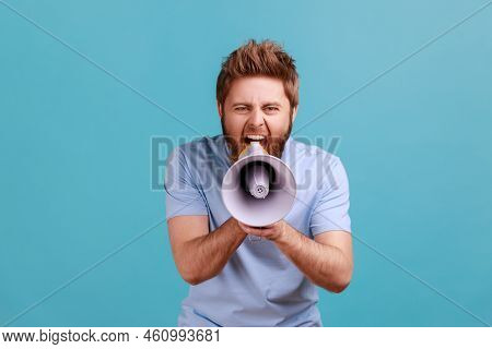 Portrait Of Bearded Man Holding Megaphone Near Mouth, Loudly Speaking, Screaming, Making Announcemen