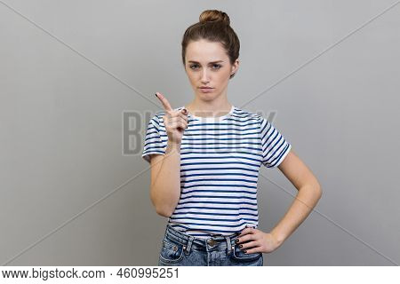 Portrait Of Woman Wearing Striped T-shirt Pointing Finger At Camera And Looking With Dissatisfied Ex
