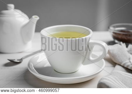 Cup Of Buckwheat Tea On White Wooden Table