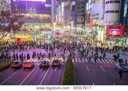 TOKYO - DECEMBER 10: Pedestrians cross at Shibuya Crossing on December 10, 2013 in Tokyo, Japan. The crosswalk is one of the world's most famous implementations of a scramble crosswalk.