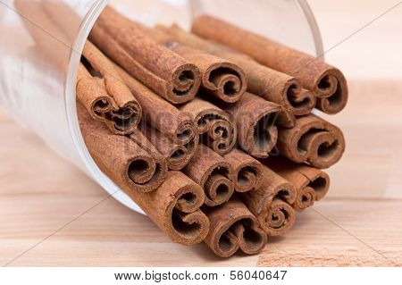 Cinnamon sticks on a wood plateau