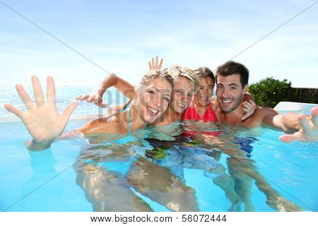 Happy family enjoying bath time in infinity pool