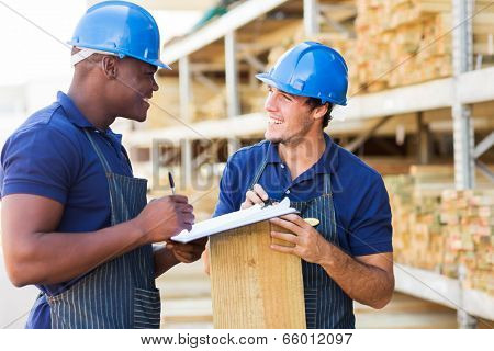 two male hardware store workers working in timber yard