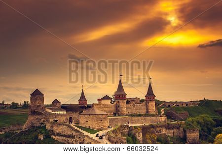 Sunset view on the castle in Kamianets-Podilskyi in spring. Ukraine