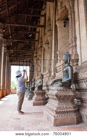 Vientien , Laos - May 1 : Unidentified Woman Take A Photograph Of A Buddha Statue On May 1 , 2009 In