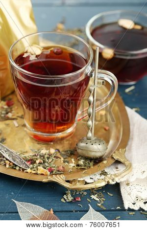 Beautiful vintage composition with herbal tea, on wooden table