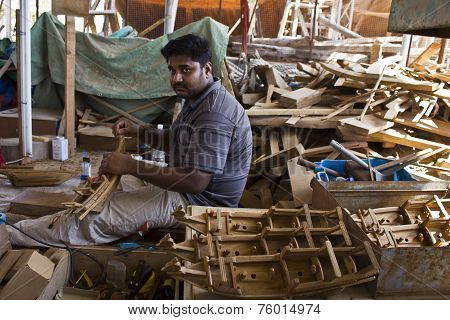 Man At Work Building A Boat