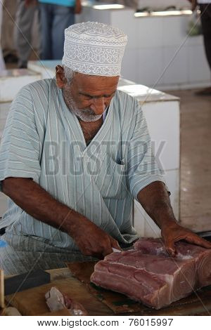 Fisherman cutting the fish