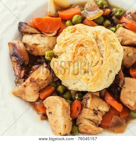 A homemade version of chicken pot pie with a biscuit topping.