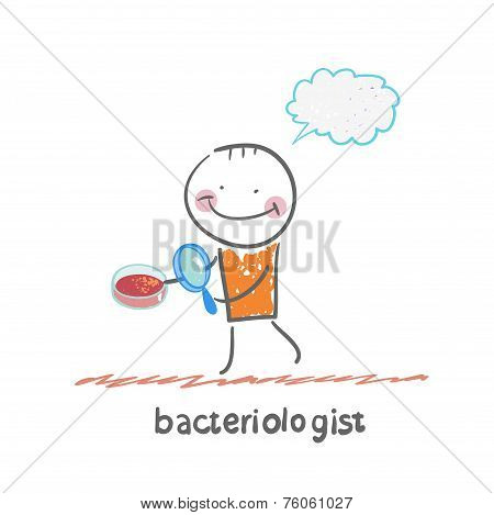 bacteriologist looks through a magnifying glass on microbes