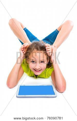 Flexible contortionist kid girl playing with tablet pc on white background