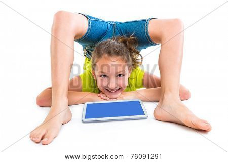 Flexible contortionist kid girl playing with tablet pc on white background