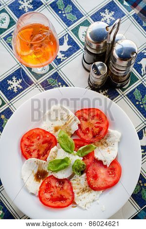 A cheese platter with tomatoes and basil