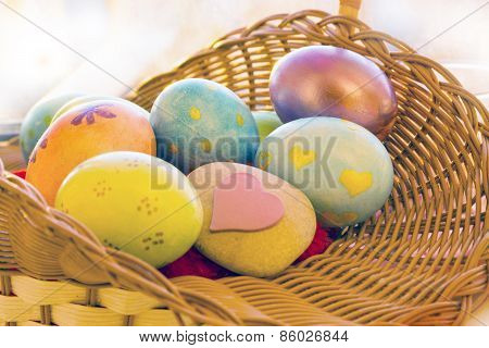 Easter eggs in a basket with a stone in the morning