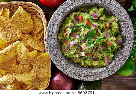 mexican guacamole in molcajete with tortilla chips