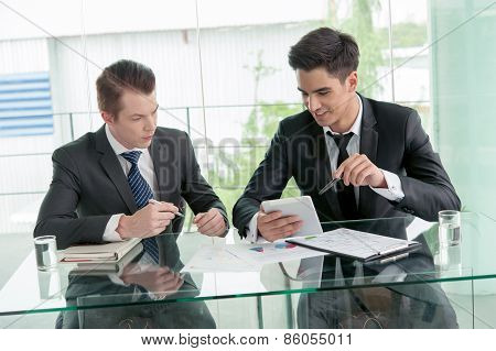 Two Businessman Using Tablet In Meeting