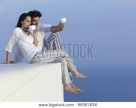 happy young romantic couple have fun relax smile at modern home outdoor terace balcony terace