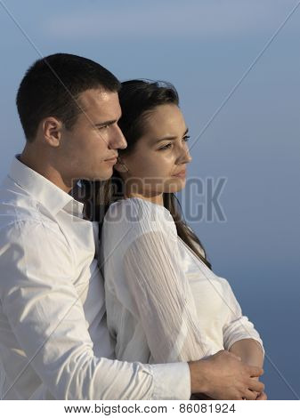 happy young romantic couple have fun relax smile at modern home outdoor terace balcony terace